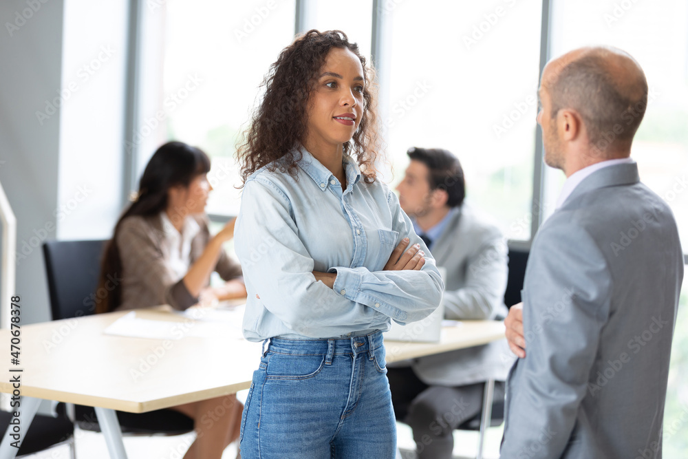 businesswoman talking and explaining about works with colleague in meeting room businesswoman talking and explaining about works with colleague in meeting room