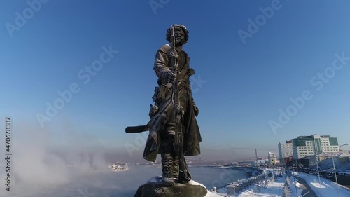 Monument to the founders of Irkutsk Yakov Pokhabov on the banks of the Angara River. drone shooting. Winter weather, soaring water.