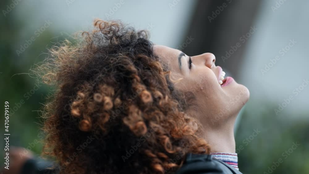 Carefree woman looking up at sky opening eyes feeling happy Carefree woman looking up at sky opening eyes feeling happy
