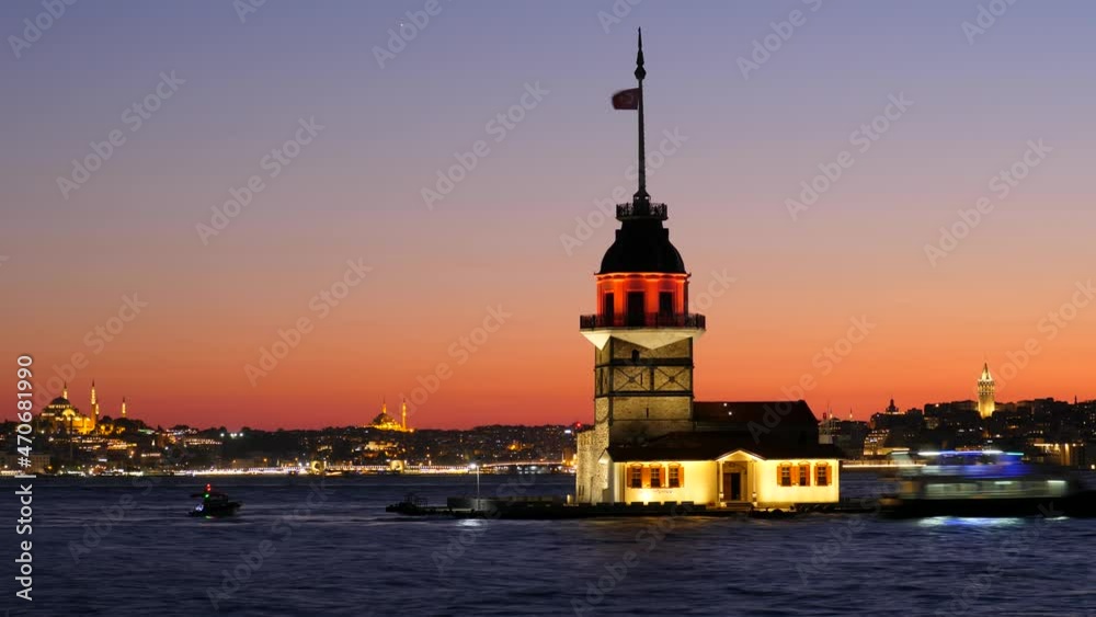 Maiden's Tower after sunset, time lapse shot of Istanbul from Asian side, many boats and ships move by Bosporus. Sky become dark, city mosques and Galata Tower seen illuminated in yellow light Maiden's Tower after sunset, time lapse shot of Istanbul from Asian side, many boats and ships move by Bosporus. Sky become dark, city mosques and Galata Tower seen illuminated in yellow light