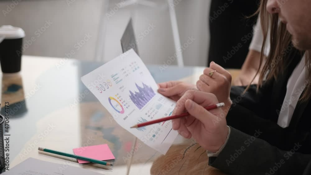 Business team analyzing income charts and graphs with modern laptop computer. Close up business analysis and strategy.