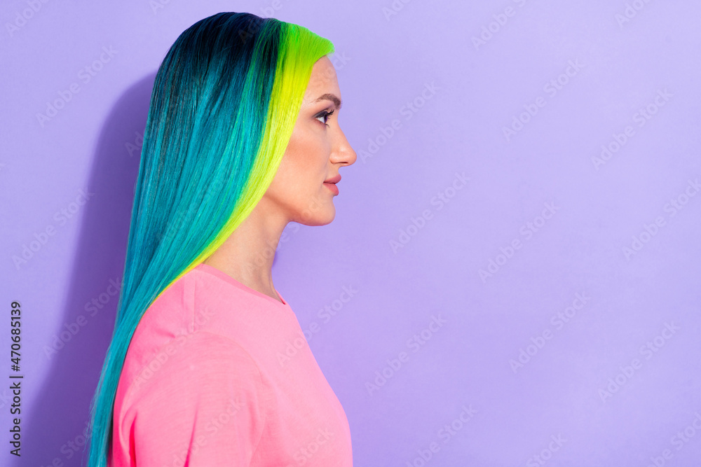 Profile side photo of millennial blue teal different color haired lady look empty space isolated over violet color background Profile side photo of millennial blue teal different color haired lady look empty space isolated over violet color background