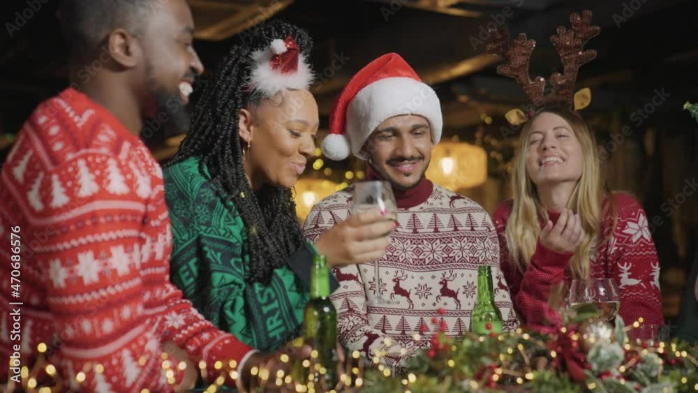 Low Angle Shot of a Group of Friends Celebrating Christmas at Bar Low Angle Shot of a Group of Friends Celebrating Christmas at Bar