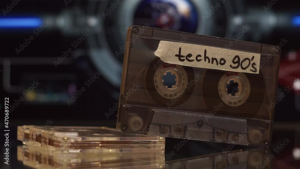 An audio cassette with the inscription Techno 90's on the background of ...