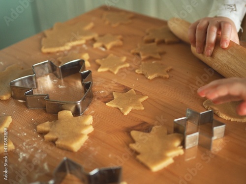 Little girl rolling Christmas ginger cookie dough. Cooking and baking. Background with place for text