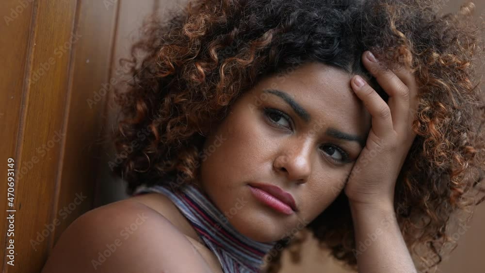 Pensive Brazilian woman thinking deeply about problems Pensive Brazilian woman thinking deeply about problems