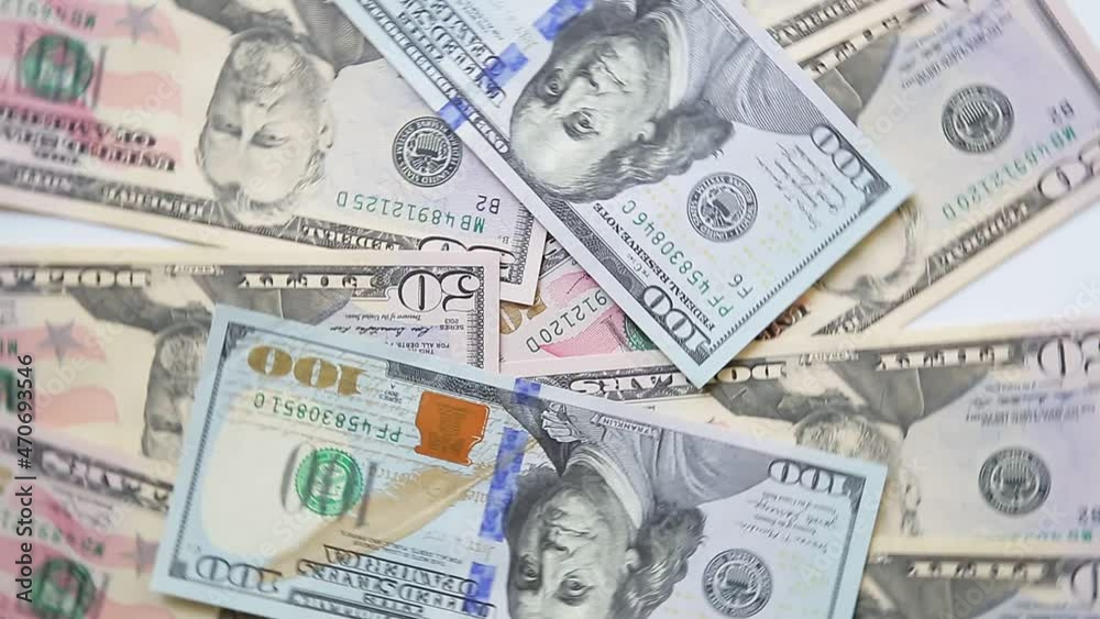 Dollar bills fifty and one hundred spread out on the table rotate in a circle Dollar bills fifty and one hundred spread out on the table rotate in a circle