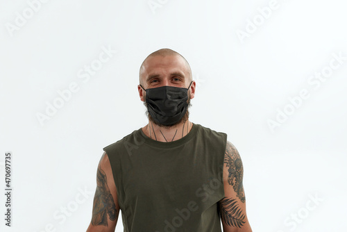 Young man in medical mask looking at camera © Svitlana