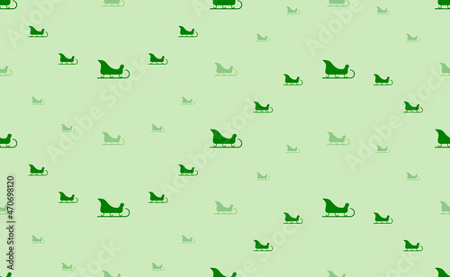Seamless pattern of large and small green sleigh symbols. The elements are arranged in a wavy. Vector illustration on light green background © Alexey