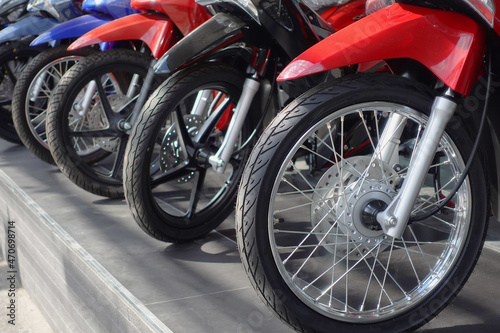 new motorcycle for sale parked in a row in front of motorcycle shop  selective focus