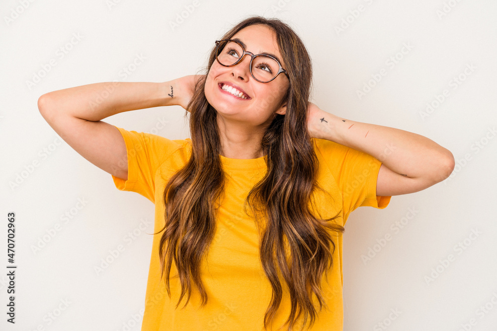 Young caucasian woman isolated on white background feeling confident, with hands behind the head. Young caucasian woman isolated on white background feeling confident, with hands behind the head.