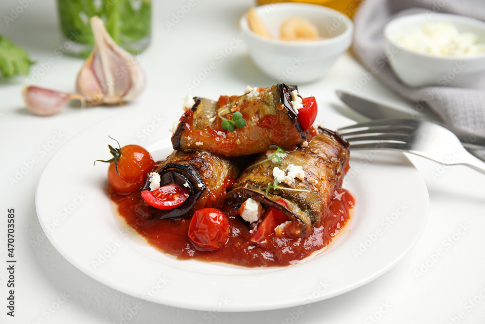 Tasty eggplant rolls served on white table, closeup Tasty eggplant rolls served on white table, closeup