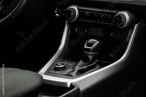 Car interior console close up view. Gear stick with multimedia console.