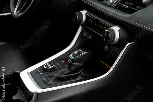 Car interior console close up view. Gear stick with multimedia console. © Roman