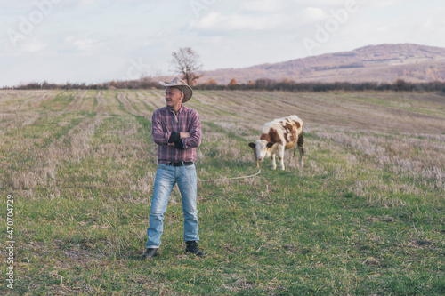Rancher and his cows on pasture