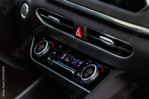 Red triangle hazard light button on car dashboard. Car media buttons dashboard. Detail of a modern car controllers.