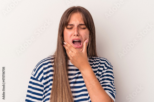 Young caucasian woman isolated on white background having a strong teeth pain, molar ache. © Asier