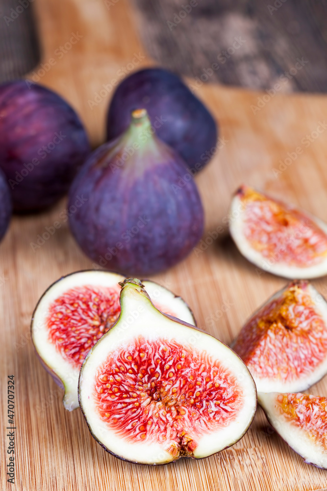 ripe purple figs on a wooden table