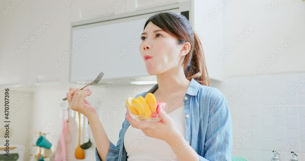 Asian pregnant woman prepare fruit Asian pregnant woman prepare fruit