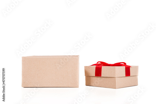 Gift box wrapped in recycled paper with red ribbon  isolated