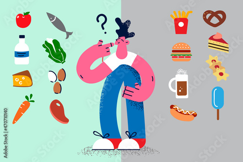 Pensive man decide among healthy and unhealthy food