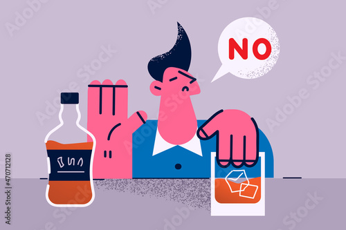 Young man refuse from alcohol drink at bar