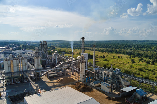 Aerial view of oil and gas refining petrochemical factory with tall refinery plant manufacture structure.