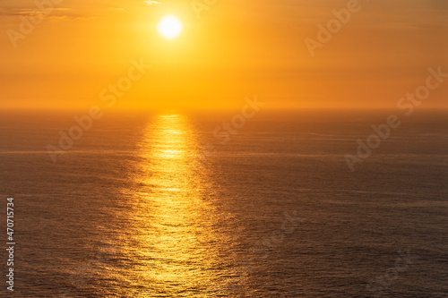beautiful sunset on the calm sea surface as a natural background