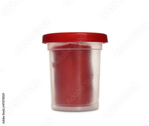 Plastic container of red play dough isolated on white
