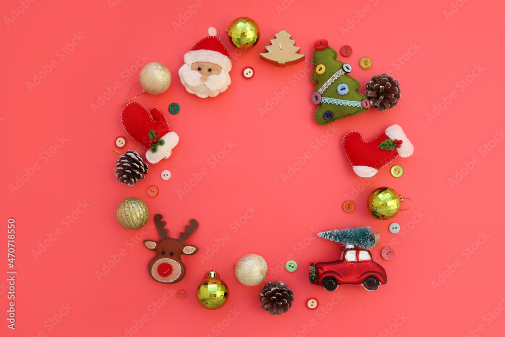 Christmas composition of handmade felt toys in the form of wreath with space for copy space. Red toy car, felt Santa, deer, Christmas tree, mittens on yellow background. Concept of Christmas new year. Christmas composition of handmade felt toys in the form of wreath with space for copy space. Red toy car, felt Santa, deer, Christmas tree, mittens on yellow background. Concept of Christmas new year.