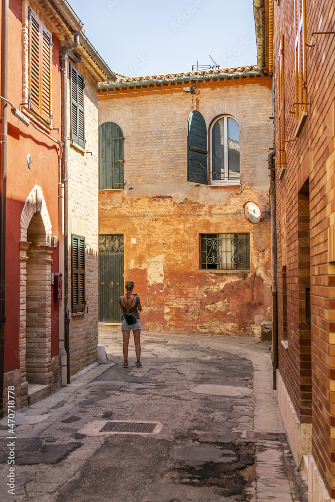 Girl photographing in the streets of Recanati. August 2021 Recanati, Marche - Italy