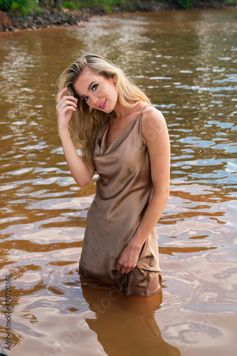 Fototapeta Naklejka Na Ścianę i Meble -  A Lovely Blonde Model Enjoys A Day At The Lake