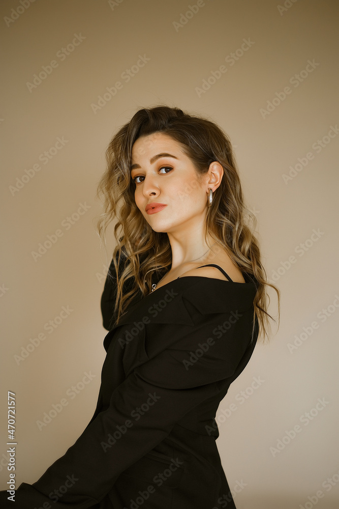 portrait of young beauty caucasian woman in a black suit , a girl with makeup and curly hair in jacket, a dark eyes lady with earrings-rings and bright makeup on light background portrait of young beauty caucasian woman in a black suit , a girl with makeup and curly hair in jacket, a dark eyes lady with earrings-rings and bright makeup on light background