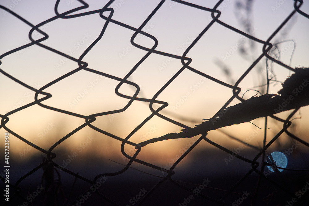 Iron mesh against evening sky Iron mesh against evening sky