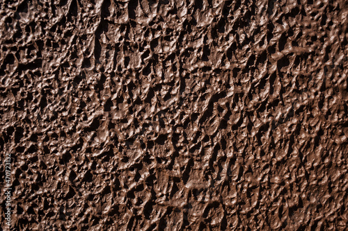 Texture brown wall with decorate relief plaster. Front view