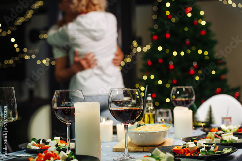 Dining table with salads and red wine ready for christmas celebration.