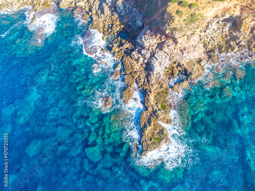 Aerial view of rough sea by a rocky shore in Sardinia