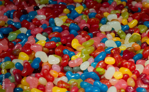 Lots of colorful jelly bean candies sale by weight. Sweet bright background
