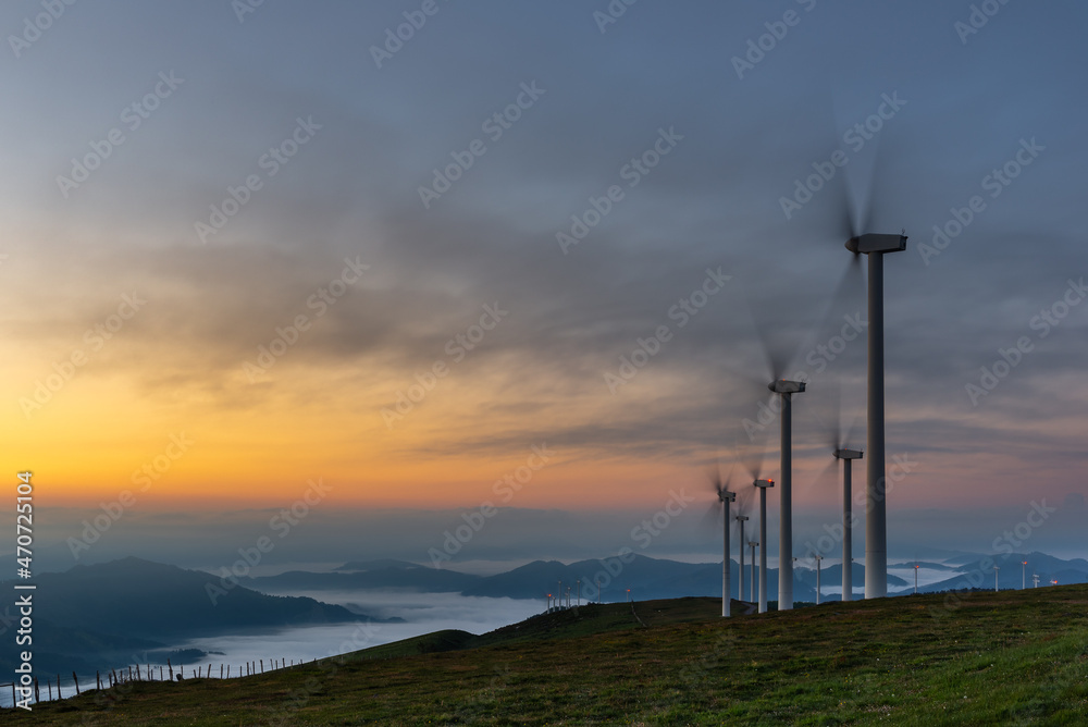 Obraz premium Wind turbines farm at sunrise, Oiz mountain, Basque Country, Spain