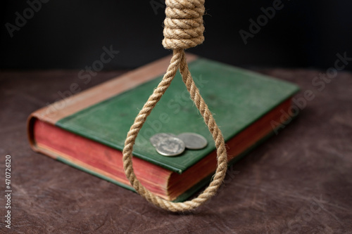 Canvas-taulu old bible with red pages, a hangman noose and 3 coins, representing the betrayal