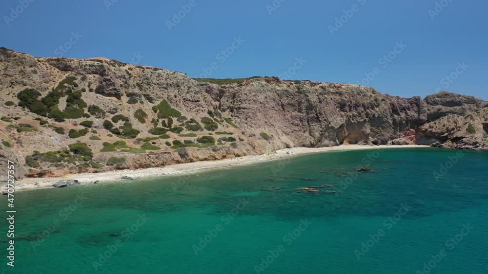 Aerial drone video of scenic colourful volcanic rocky bay and emerald sandy beach of Palaochori a natural vacation paradise with resorts and water sport facilities in island of Milos, Cyclades, Greece Aerial drone video of scenic colourful volcanic rocky bay and emerald sandy beach of Palaochori a natural vacation paradise with resorts and water sport facilities in island of Milos, Cyclades, Greece
