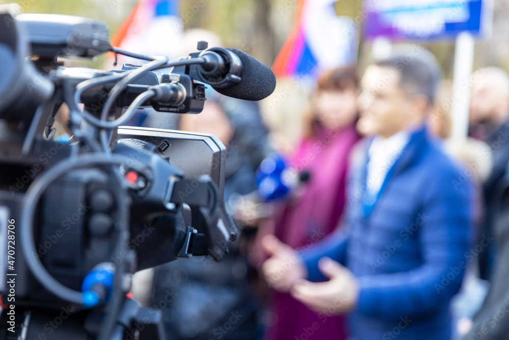 Filming media event with a video camera. News or press conference. Filming media event with a video camera. News or press conference.