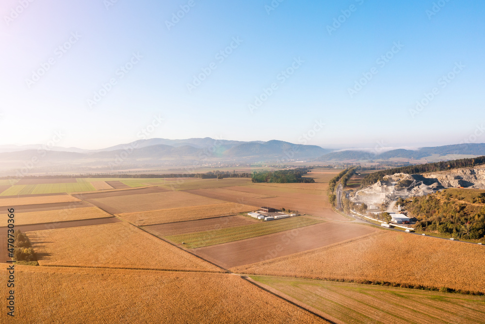 Aerial view of agricultural fields against blue sky