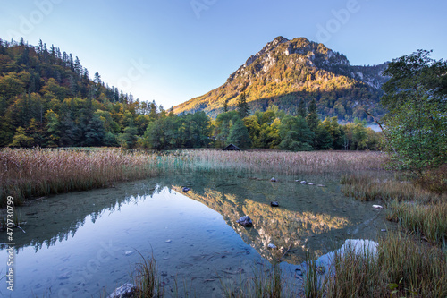 Idyllic mountain lake Leopoldsteinersee surrounded by mountains in Austria in the morning during autumn