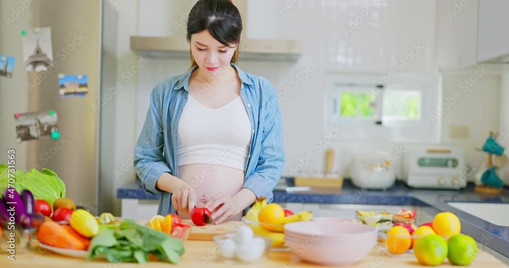 Asian pregnant woman prepare salad Asian pregnant woman prepare salad