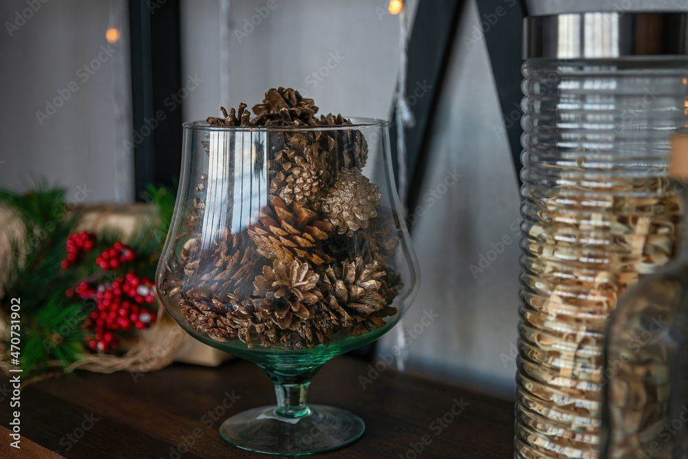 Large glass vase with pine cones. Natural Decorating for Christmas. New year holiday, celebration concept