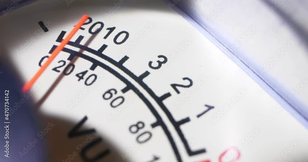 detailed extreme close-up, moving arrow of analog VU meter scale. detailed extreme close-up, moving arrow of analog VU meter scale.
