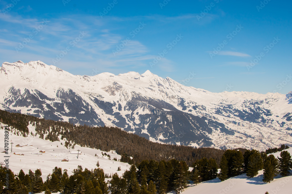 Beautiful panoramic view of snow-capped mountains in the Swiss Alps.