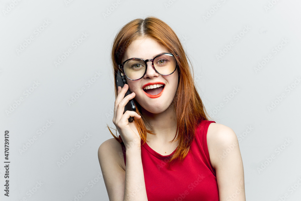 emotional red-haired woman with a phone in her hands communicating gadget emotional red-haired woman with a phone in her hands communicating gadget