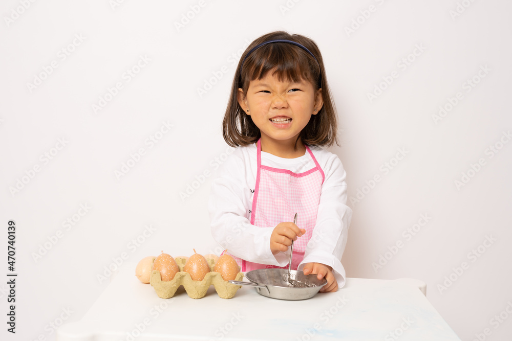Beautiful little asian girl cooking isolate on white background Beautiful little asian girl cooking isolate on white background
